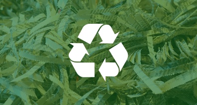 A pile of shredded paper with a green overlay and a recycling icon in the center