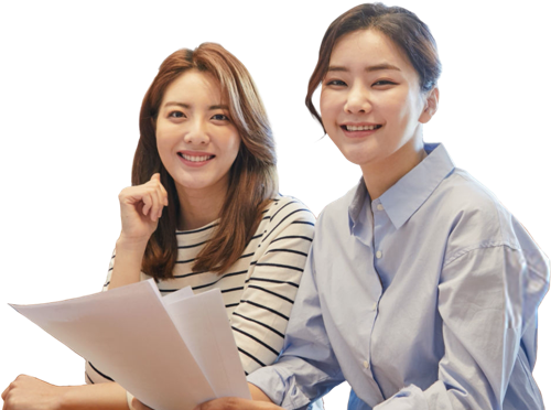 Two women smiling while discussing business.