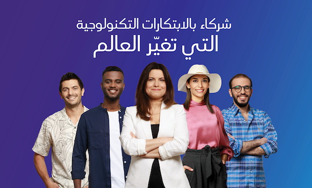 Group of people standing together smiling.