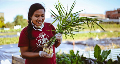 A person holding a freshly harvested plant.